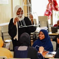A facilitator presenting a model built during a group activity