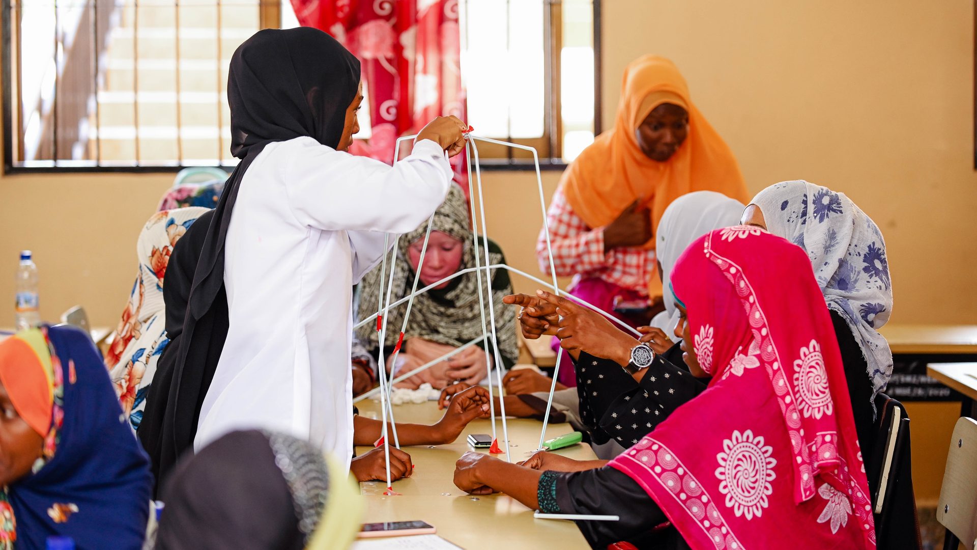 Young people working together on a practical group activity at a Kijana Hai Foundation workshop