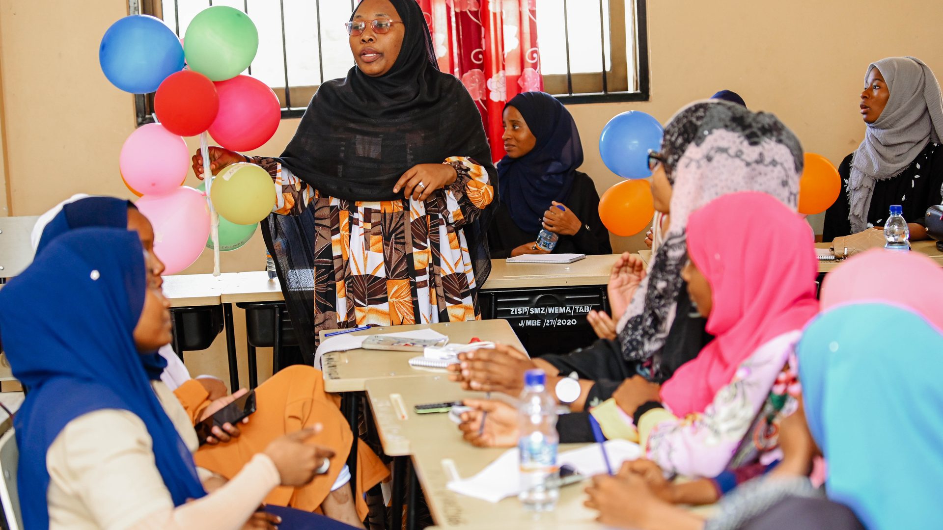 A Kijana Hai Club facilitator leading a session with a full room of participating learners
